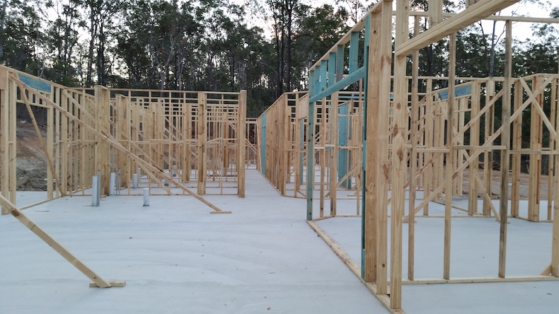 A home being constructed with timber framing on a concrete slab