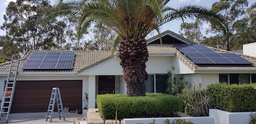 Single storey home facade with solar panels on the roof