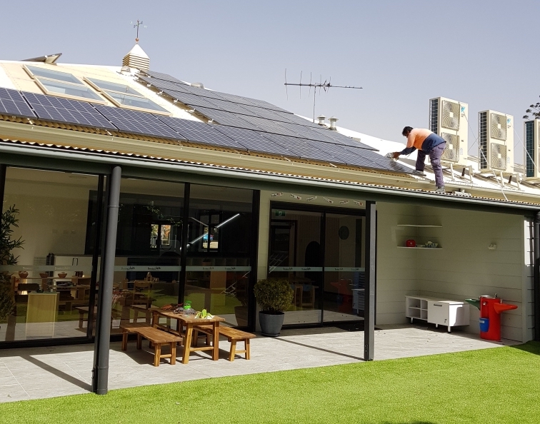 Expert solar electrician at work on a roof with solar panels